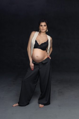 Kobieta w ciąży stojąca w studio – fotografia ciążowa Wyszków